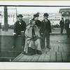 Two men and two women waiting at train station at Camp Black, Long Island, New York