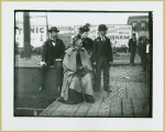 Two men and two women waiting at train station at Camp Black, Long Island, New York