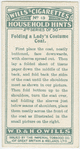 Folding a lady's costume coat.
