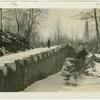 Man standing along stone wall