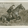Taking a fence : sount and West Wilts. foxhounds at Mere, Wilts.