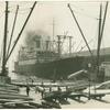 Transferring lumber from a coast wise boat to the S.S. President Lincoln of the Dollar Steamship Co. headed for the Far East, from San Francisco