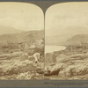 Destroyed St. Pierre, from it southern end, north to steaming Mont Pelée, Martinique, W. I.