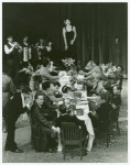 Helen Schneider (on table) and cast