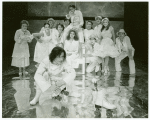 Caitlin Clarke (foreground), Anthony Heald, and Mary Elizabeth Mastrantonio (on chair) in the stage production The Marriage of Figaro