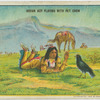 Indian boy playing with pet crow.
