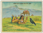 Indian boy playing with pet crow.