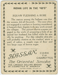 Squaw fleshing a robe.