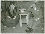 American Telephone & Telegraph Exhibit - Adolph Menjou and his wife listening in on phone conversation