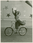 Amusements - American Jubilee - Scenes - Bicycle Number - Tina Regat on bicycle