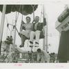 Amusements - Games and Rides - Parachute Jump - Man and woman on ride