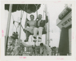 Amusements - Games and Rides - Parachute Jump - Man and woman on ride