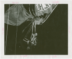 Amusements - Games and Rides - Parachute Jump - Man and woman suspended on jammed ride