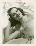 Amusements - Performers and Personalities - Constance Moore in white lace dress