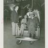 Amusements - Performers and Personalities - Barbara Bennett and man riding in American Express push chair