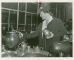Amusements - Performers and Personalities - Lotte Lehman examines pottery at Danish Pavilion