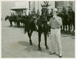 Amusements - Performers and Personalities - Gene Autry with horse eating hotdog
