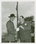 Amusements - Performers and Personalities - Arnold E. slipping coin to Fair patrolman
