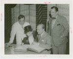 Amusements - Performers and Personalities - Bergen, Edgar - Signing guestbook with Charlie McCarthy, Fiorello LaGuardia and Grover Whalen