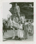 Amusements - Performers and Personalities - Fairbanks, Douglas Sr. and Jr. - Douglas Fairbanks Jr. standing on camel held by Frank Buck