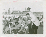 Amusements - Performers and Personalities - Musicians - Guy Lombardo and the Royal Canadians - Eating hot dog and signing autographs