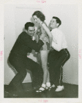 Amusements - Performers and Personalities - Showgirls - Men trying to lift girl