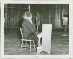 Amusements - Shows and Attractions - Frank Buck's Jungleland - Monkeys and Chimpanzees - Chimpanzee in costume playing piano