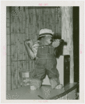 Amusements - Shows and Attractions - Frank Buck's Jungleland - Monkeys and Chimpanzees - Chimpanzee in costume with beer bottle