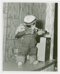Amusements - Shows and Attractions - Frank Buck's Jungleland - Monkeys and Chimpanzees - Chimpanzee in costume with beer bottle