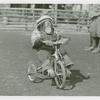 Amusements - Shows and Attractions - Frank Buck's Jungleland - Monkeys and Chimpanzees - Chimpanzee in costume on tricycle