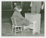 Amusements - Shows and Attractions - Frank Buck's Jungleland - Monkeys and Chimpanzees - Chimpanzee in costume on piano