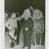 Amusements - Shows and Attractions - Wild West - Indian man putting headdress on Grover Whalen