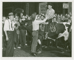 Amusements - Shows and Attractions - Wild West - Man on bull shaking hands with man on ground
