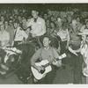 Amusements - Shows and Attractions - Wild West - Man riding bull while other man plays guitar