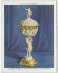 Carved ivory cup with jewelled mounts.