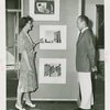 Art Exhibits - American Art Today - Woman showing artwork to man
