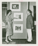Art Exhibits - American Art Today - Woman showing artwork to man