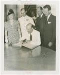 Australia Participation - L.R. MacGregor (Commissioner) signing guest register at Perylon Hall