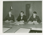 Australia Participation - L.R. MacGregor and Grover Whalen signing contracts