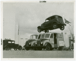 Automobiles - Death Dodgers - Car jumping over milk trucks