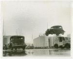 Automobiles - Death Dodgers - Car jumping over milk trucks