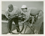 Automobiles - Model - Men using bicycle to start model car