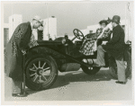 Automobiles - Ye Goode Olde Days - Man pumping tire while woman waits