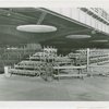 Benches stacked under overpass.