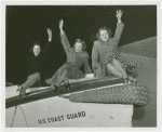 Three women on Coast Guard boat.