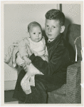 Boy holding baby