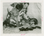Carrier Corp. - Eskimos - Man and boy with dog and puppies