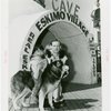 Carrier Corp. - Eskimos - Man, boy and dog outside "village".