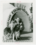 Carrier Corp. - Eskimos - Man, boy and dog outside "village".