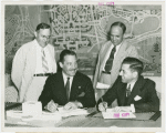 Christian Science - Grover Whalen signing contract with Christian Scientists executive committee chairman